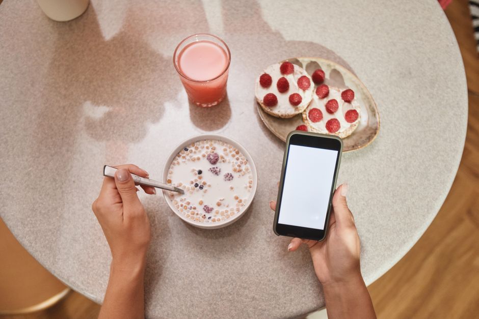 A person holding a smartphone logging nutrition