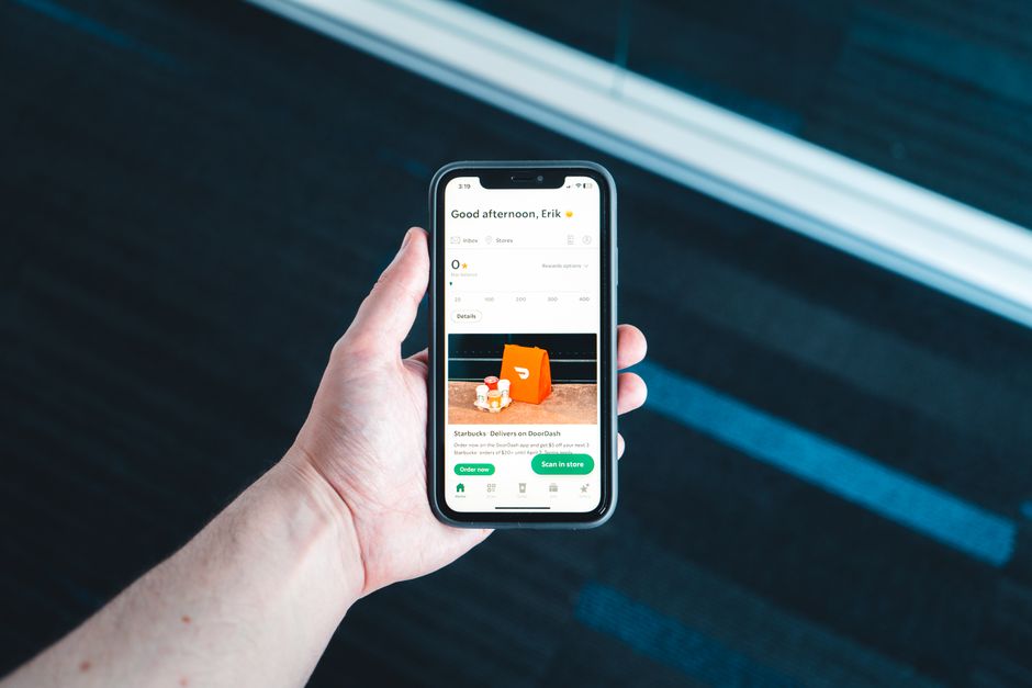 Hand holding a smartphone showing a food and nutrition app